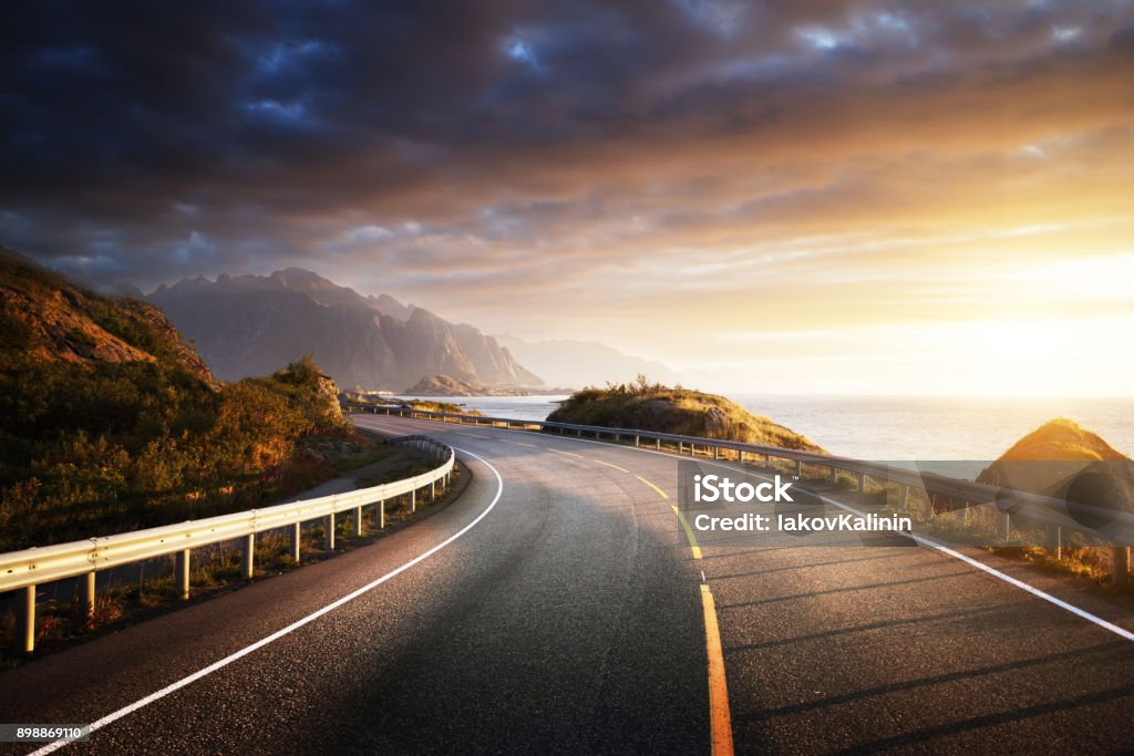 oad by the sea in sunrise time, Lofoten island, Norway Road Stock Photo