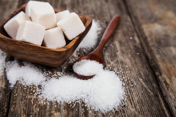 istock Bowl with sugar and a wooden spoon 898869830