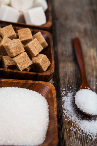 istock Three bowls with sugar and a wooden spoon 898870160