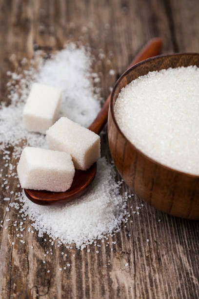 istock Bowl with sugar and a wooden spoon 898872424