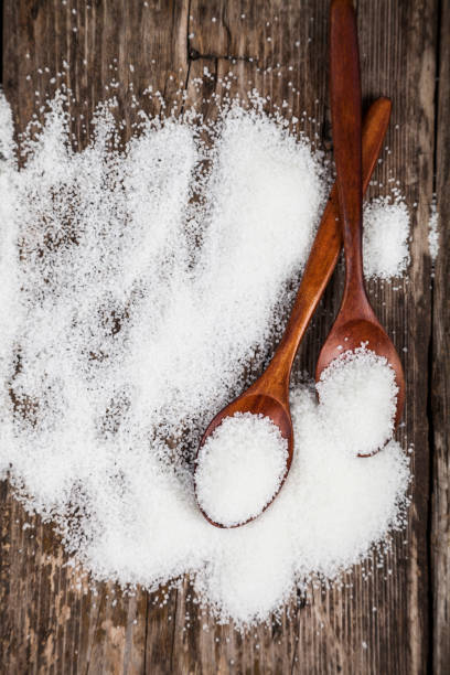 istock Two wooden spoons with sugar 898872510