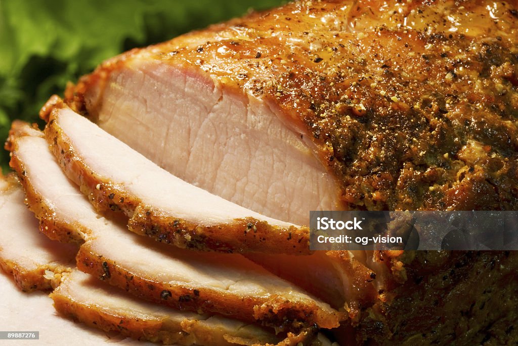 A sliced roast pork tenderloin Close-up of a roast pork tenderloin Roast Pork Stock Photo