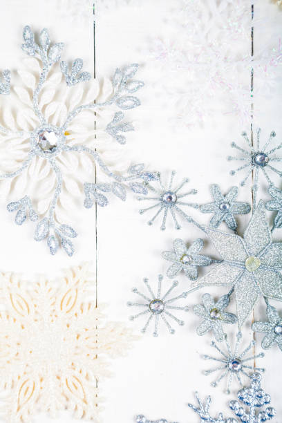 istock Silvery snowflakes on a white background 898873212