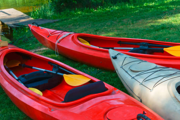 istock boats at the dock, red kayaks on the shore 898873446