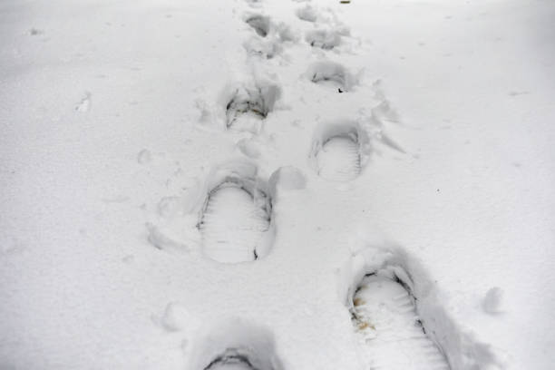 istock Footprints in the snow. Footprints on the first snow. Imprint of 898878020