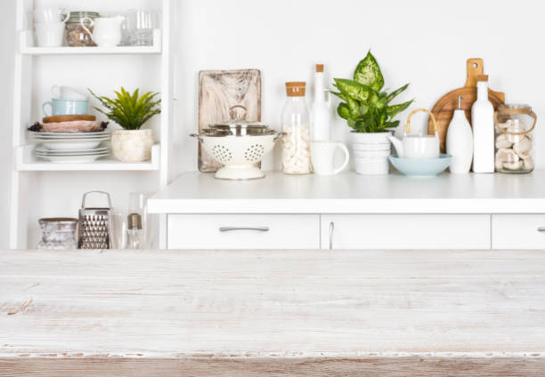 istock Wooden table over blurred image of kitchen bench and shelf 898882004