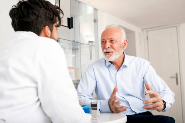 istock Senior Patient consulting With Doctor In Office 898884840
