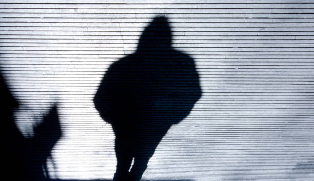 istock Blurry shadow of a person walking 898885008
