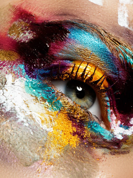 istock Beauty, cosmetics and makeup. Magic eyes look with bright creative make-up. Macro shot of beautiful woman's face with perfect art make up. Closeup of female eye. Body art 898886812