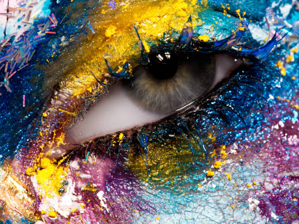 istock Beauty, cosmetics and makeup. Magic eyes look with bright creative make-up. Macro shot of beautiful woman's face with perfect art make up. Closeup of female eye. Body art 898886824