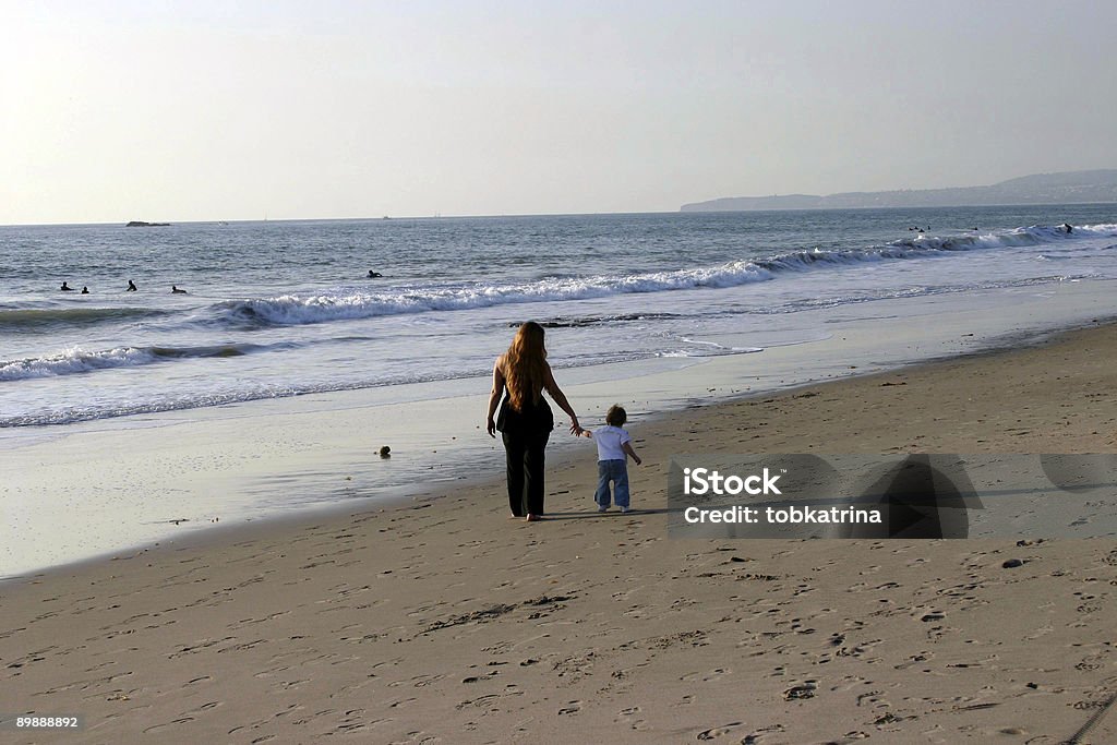 Madre e hija caminando en la playa - Foto de stock de Adulto libre de derechos