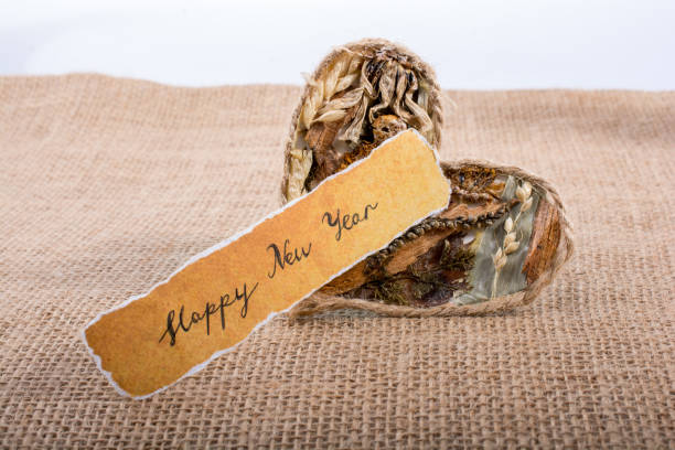 istock Happy new year written torn paper beside a heart shape 898889662