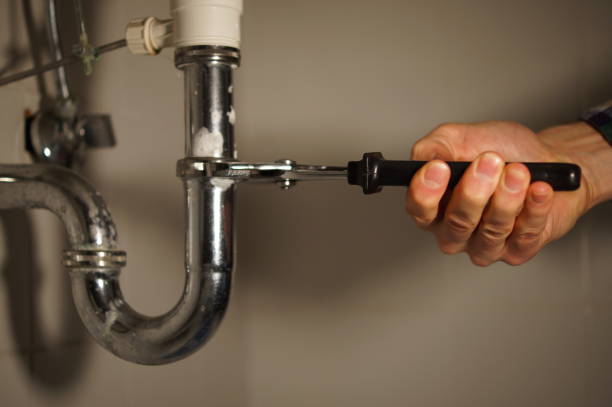 istock Plumbing repair service. Professional installer with spanner checking pipe. 898893640
