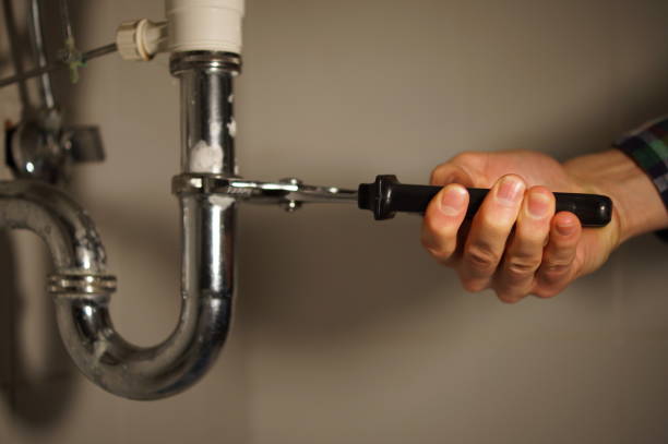 istock Plumbing repair service. Professional installer with spanner checking pipe. 898893648