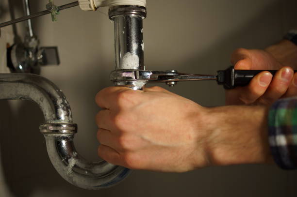 istock Plumbing repair service. Professional installer with spanner checking pipe. 898893682