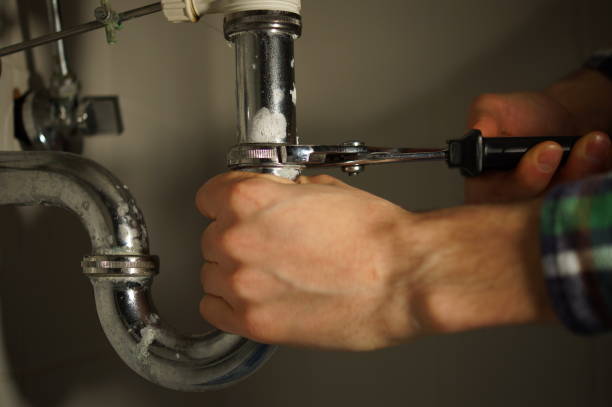 istock Plumbing repair service. Professional installer with spanner checking pipe. 898893684