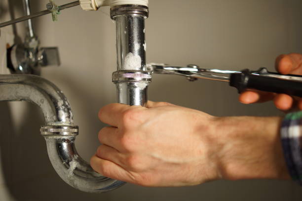 istock Plumbing repair service. Professional installer with spanner checking pipe. 898893688