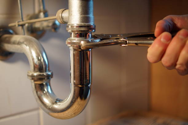 istock Plumbing repair service. Professional installer with spanner checking pipe. 898893728