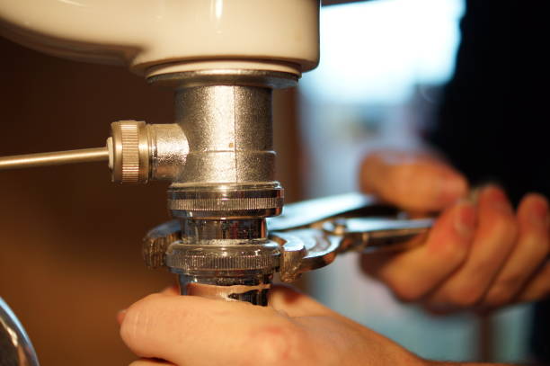 istock Plumbing repair service. Professional installer with spanner checking pipe. 898893732