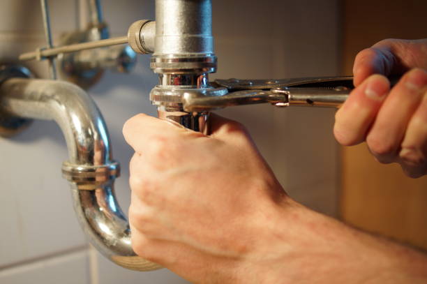istock Plumbing repair service. Professional installer with spanner checking pipe. 898893742