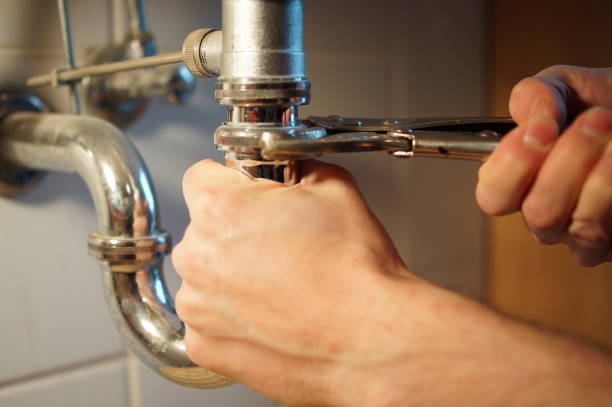 istock Plumbing repair service. Professional installer with spanner checking pipe. 898893748