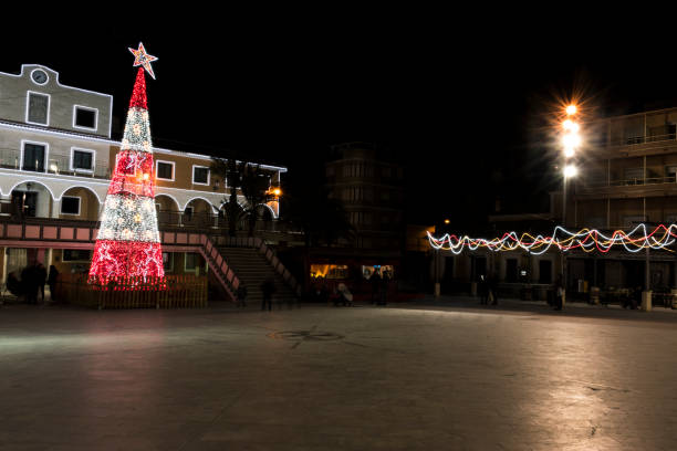 istock Christmas lighting in a village. Town Hall Square 898898414