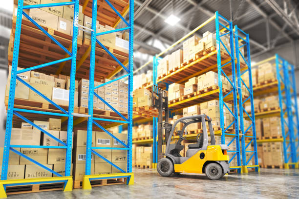 istock Concept of warehouse. The forklift between rows in the big warehouse. 898902666