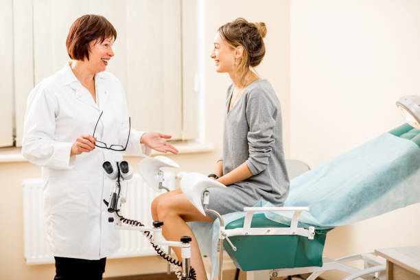 Young woman patient with gynecologist in the office Young woman patient with a senior gynecologist during the consultation in the gynecological office gynecological examination photos stock pictures, royalty-free photos & images