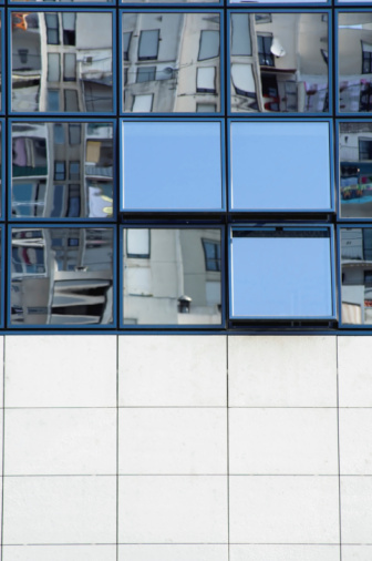 Reflections in a modern facade with empty lower part