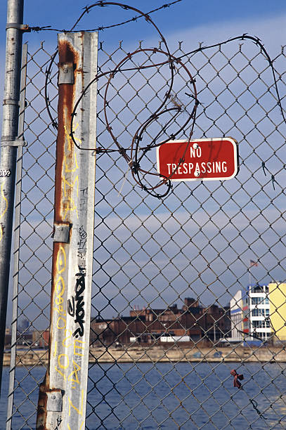 istock No Trespassing sign on barbed wire fence 89890618