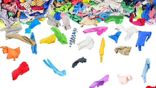 istock Separate clothing fall from a large pile of clothes on a white background 898906524