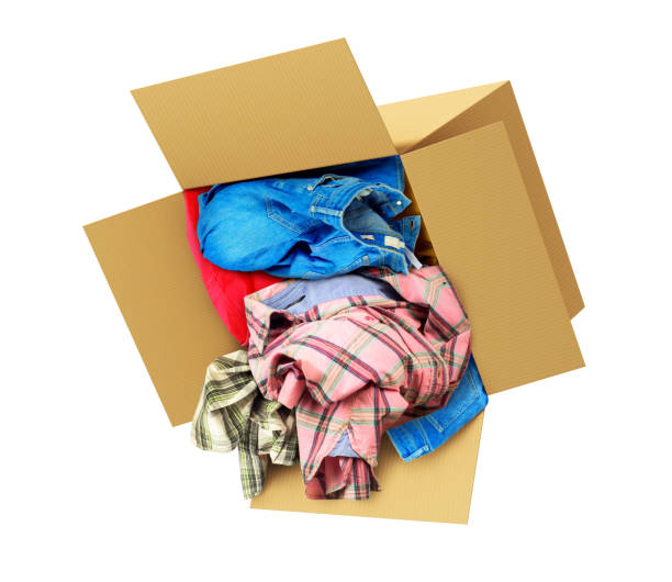 istock Cardboard box with clothes isolated on white background. Donation. 898906832
