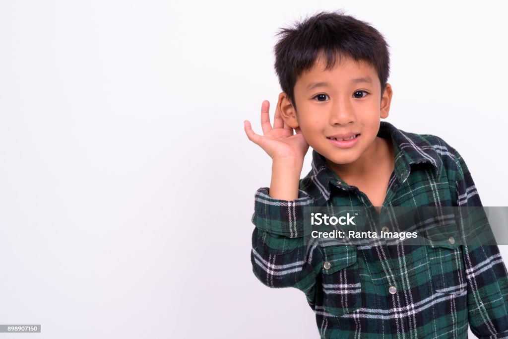 Portrait of cute Asian boy against white background Studio shot of cute Asian boy against white background Child Stock Photo