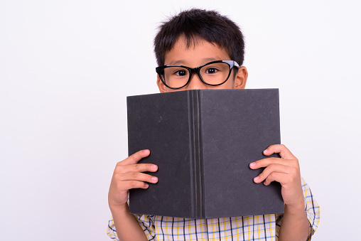 Studio shot of cute Asian boy against white background