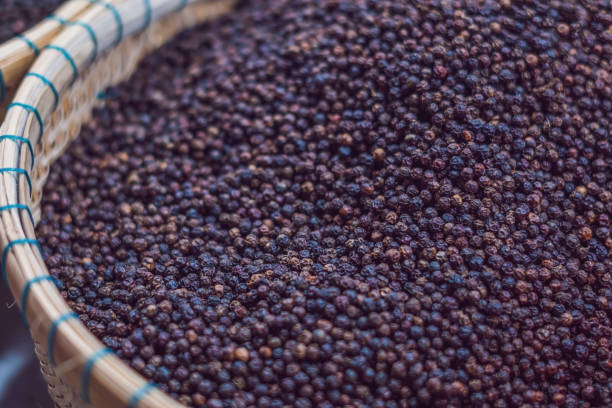 istock Black pepper grains as background close up 898907984