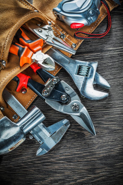 istock Leather building belt with construction tooling on wooden board 898920540