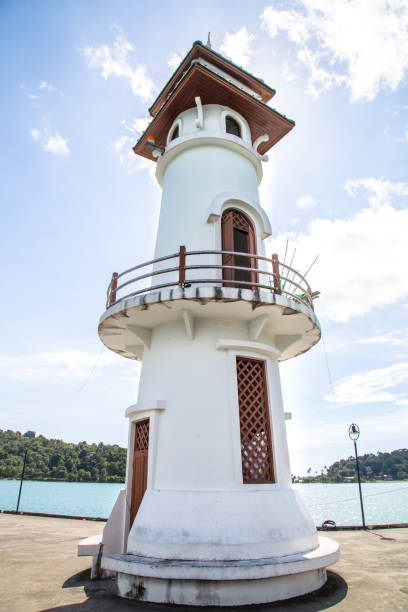 istock white lighthouse on the pier, beautiful building 898920738