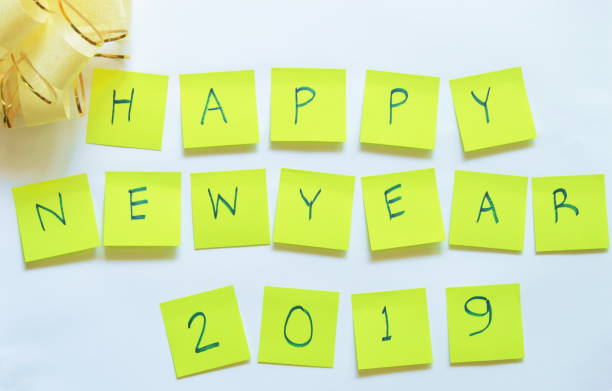 istock paper note writing happy new year 2019 and ribbon bow on white background 898924946