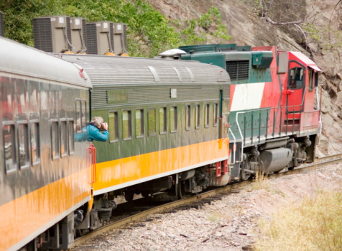 train on the railroad with mountain and blue sky background in autumn season newzealand