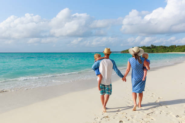 istock happy family with two kids walk on beach 898932830