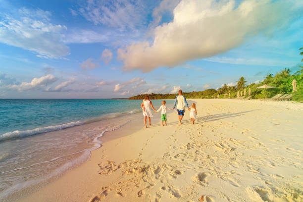 istock happy family with three kids walk on beach 898932974