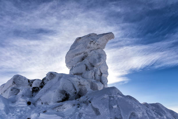 istock Unusual rock plastered with snow. Winter forest landscape 898934320