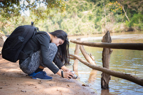 istock Asian woman backpack taking a photo with mirrorless camera 898936578