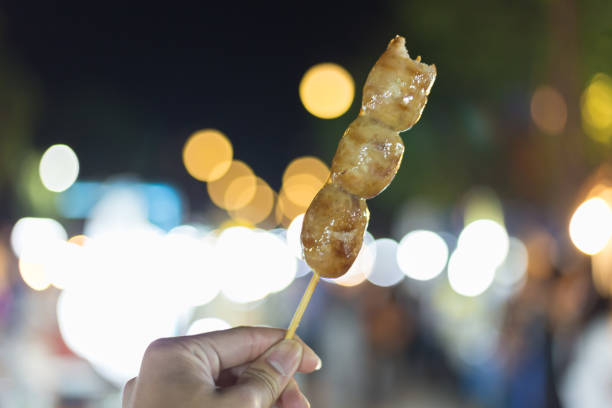 istock Thai style grilled pork sausage with bamboo sticks 898936640