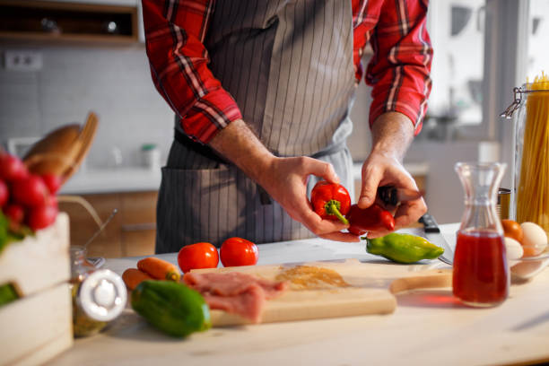 istock Man cooking at home 898936918