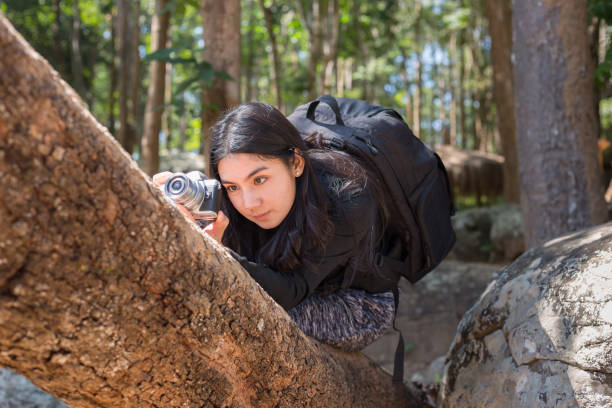 istock Asian woman backpack taking a photo with mirrorless camera 898937702