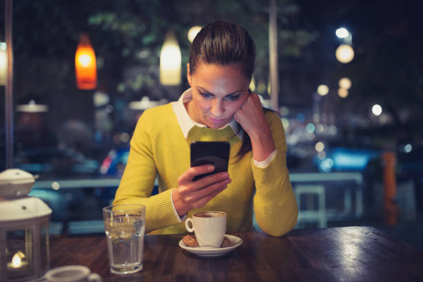 istock Single. Young woman in a cafe using mobile phone. Shallow DOF 898938028