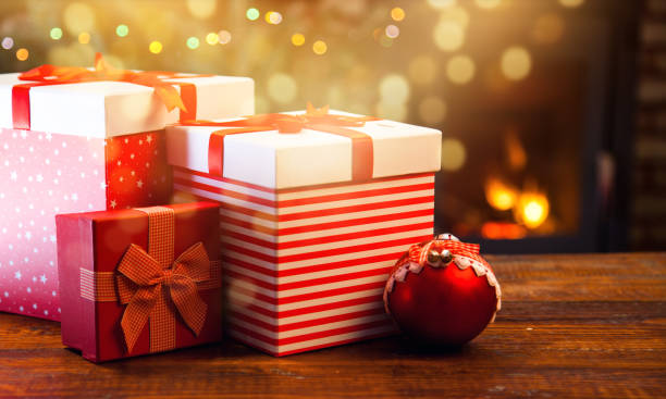 istock red gift boxes and burning fireplace in the background 898938522