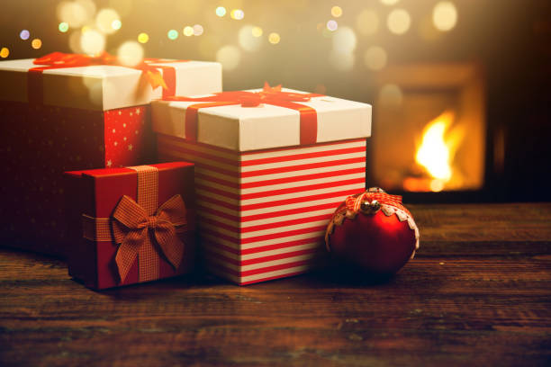 istock red gift boxes and burning fireplace in the background 898938540