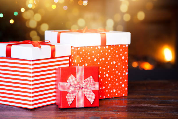 istock red gift boxes and burning fireplace in the background 898938558